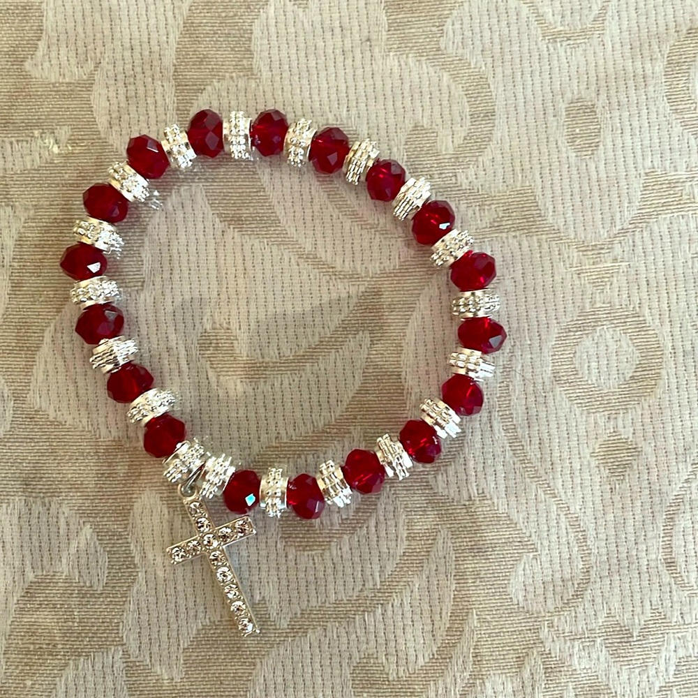 Beautiful red beaded bracelet with shiny cross